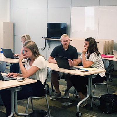Lukas Gotto works with staff members of Alexandria Public Schools during a professional development session.